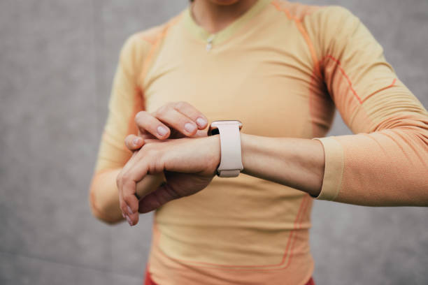 istock Active Woman Checking Fitness Tracker During Workout Outdoors 2053695005