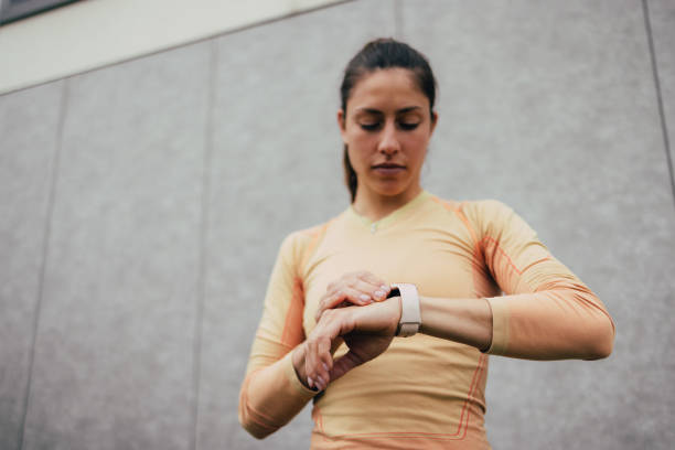 istock Focused Female Runner Checking Smartwatch During Outdoor Training 2053695016