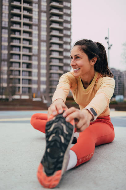 istock Active Young Woman Stretching Outdoors Urban Background 2053696104