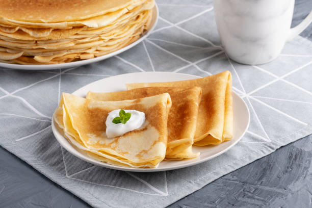 istock Stack of russian thin pancakes blini with fresh sour cream 2053737903