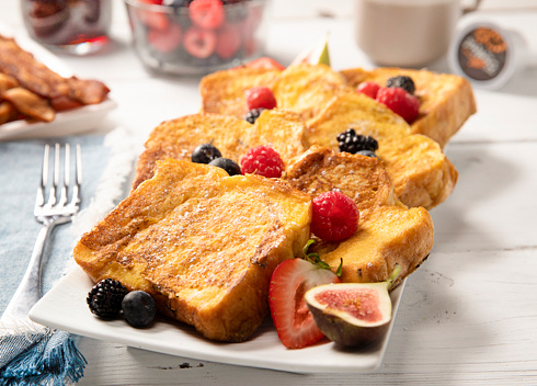 Brioche French Toast Breakfast with fresh berries, bacon and coffee