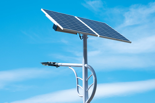 Pole mounted with solar panels and lights led illuminating.