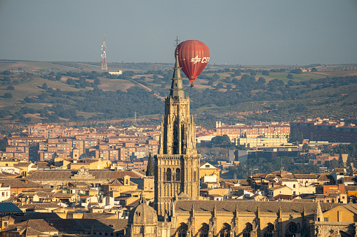 Madrid, spain, 2 January 2024: Hot air balloons flying over the city of Toledo over the Alcazar and the Cathedral