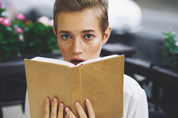 istock student with a book in his hands reading walk in the fresh air education 2053794356