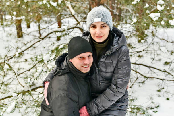 istock Two families walk in a winter snowy forest. 2053814620