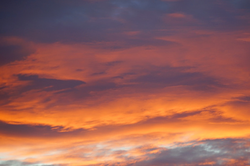 Sunset Blaze: Awe-Inspiring Sky Aglow with Orange Hues and Beautiful Clouds