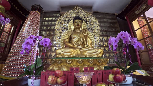 Golden Buddha in the temple.  Building interior of a Buddies temple