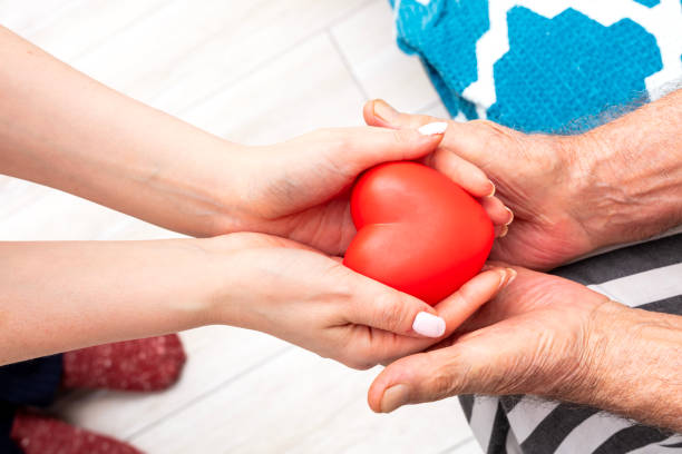 istock Close up hand giving red heart as heart donor. 2053900342