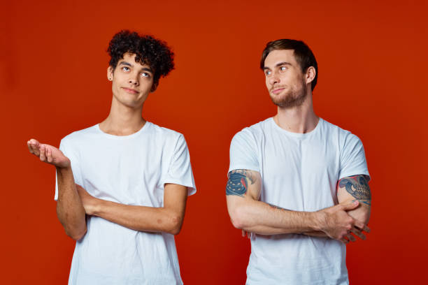 istock two friends in white t-shirts stand side by side isolated background communication 2053950001