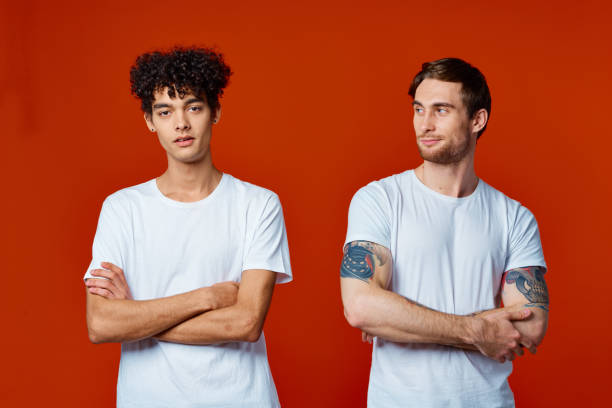 istock two friends in white t-shirts stand side by side isolated background communication 2053953600