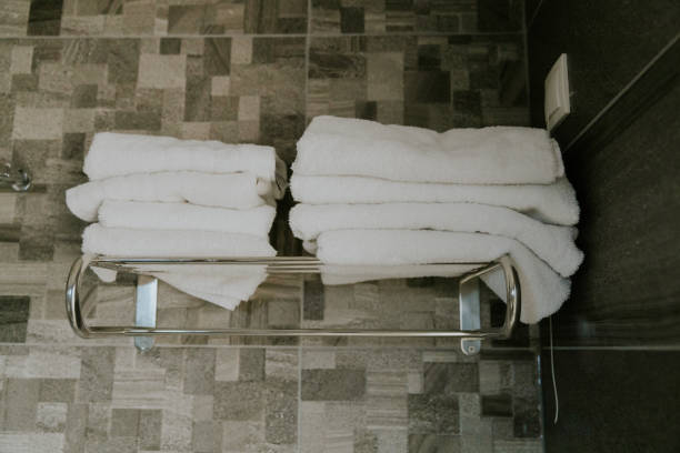 istock Clean white towels on a shelf in the shower. 2053972345
