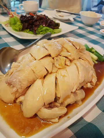 Indulge in the delicious flavors of Hainanese Chicken Rice, a traditional Asian dish renowned for its savory taste and flavorful rice. Experience culinary excellence with this iconic gastronomic delig