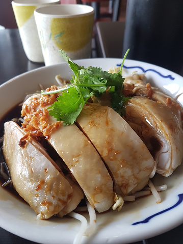 Indulge in the delicious flavors of Hainanese Chicken Rice, a traditional Asian dish renowned for its savory taste and flavorful rice. Experience culinary excellence with this iconic gastronomic delig