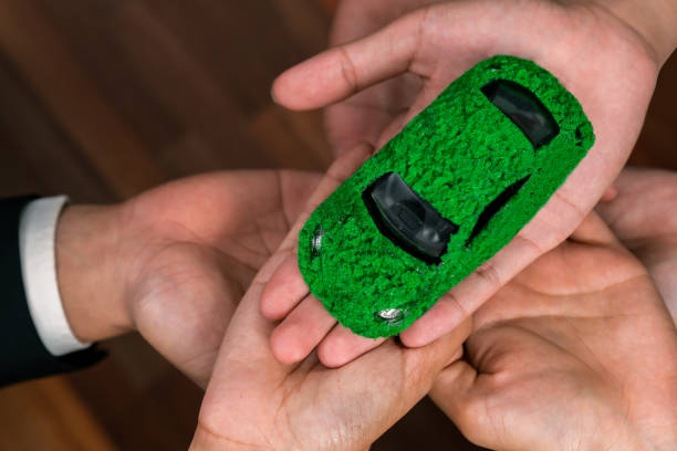 istock Business people synergy holding EV car model. Quaint 2053980921