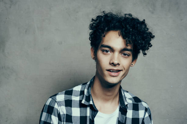 istock Cheerful guy curly hair and plaid shirt modern style studio model 2053985134
