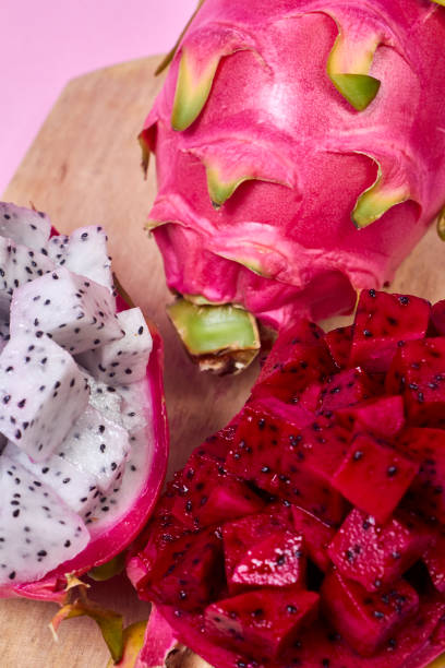 istock Red dragon fruit Set with appetizing serving on pink background. Top view 2054020167