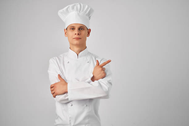 a man in a chef's uniform gesturing with a hand working in a restaurant professional. High quality photo