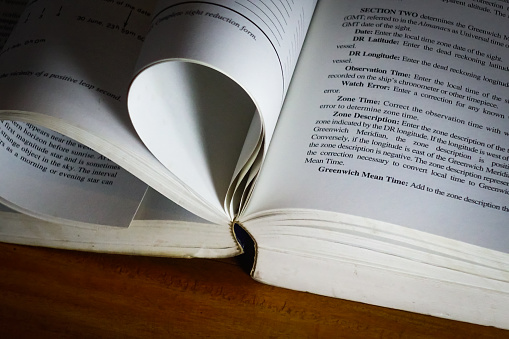 A stack of books. Photos in black and white - books stacked on top of each other - shooting up close.