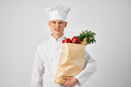 Chef with a package of groceries kitchen cooking food work. High quality photo
