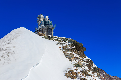 Jungfraujoch, Switzerland - August 21, 2022: View of Sphinx Observatory on Jungfraujoch, one of the highest observatories in the world located at the Jungfrau railway station, Bernese Oberland, Switzerland