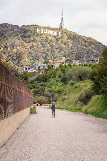 Los Angeles, CA, USA  March 1, 2024: The world famous Hollywood sign can be seen from a fire road at the Hollywood Reservoir in Los Angeles, CA.