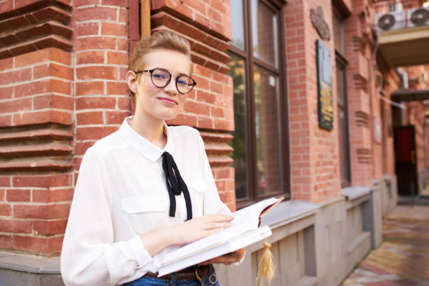 istock student with glasses walking around the city with a book Lifestyle 2054072648
