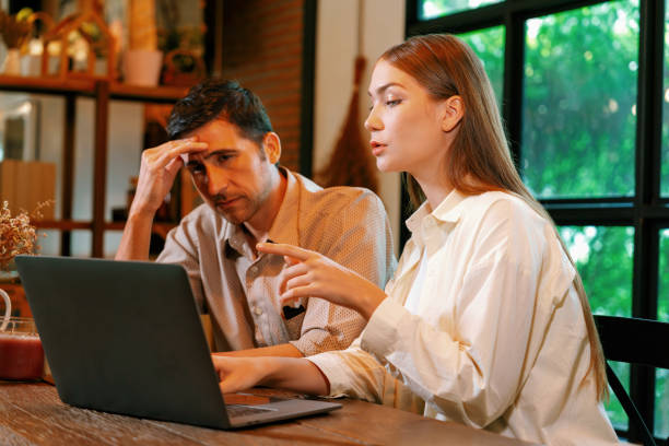 istock Young couple working remotely on laptop in cafe look tired. Expedient 2054074697