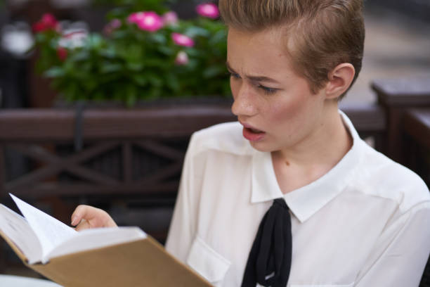 istock student with a book in his hands reading walk in the fresh air education 2054079338