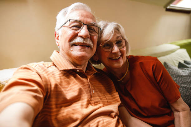 istock Senior couple smiling at camera as if they are taking selfies 2054097034