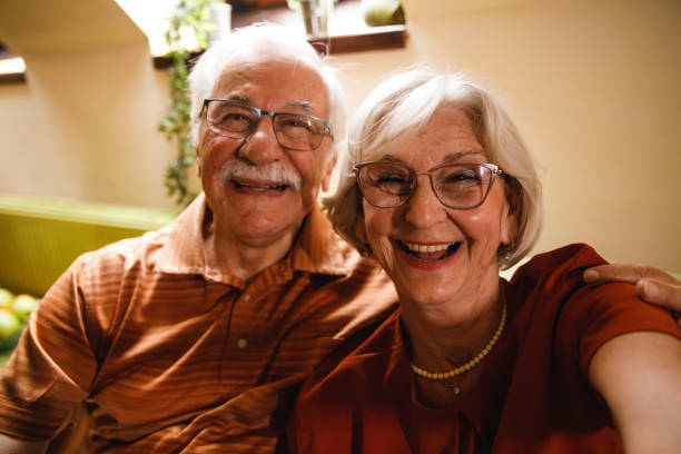 istock Senior couple smiling at camera as if they are taking selfies 2054097042