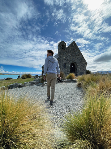 Tekapo, New Zealand - March 02 2024: Tourist visiting the iconic Lake Tekapo Church in New Zealand, a scenic destination attracting tourism with its stunning scenery.