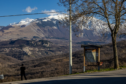 Salle, Italy, Feb 21, 2024 A person looks at the spectacular view over the Maiella range of mountains.