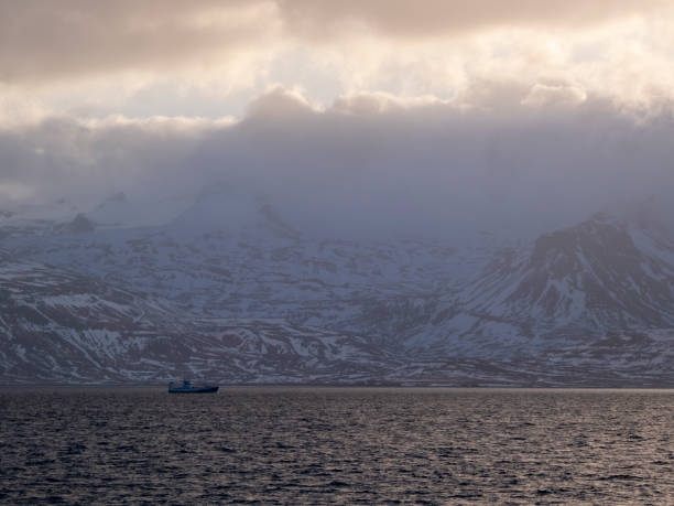 istock Boat off the snowy coast 2054113034