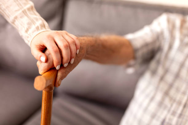 istock Home caregiver showing support for elderly patient 2054115631