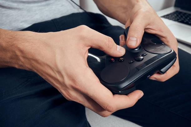 istock Gamepad male hands close-up video game addiction office technology 2054125883