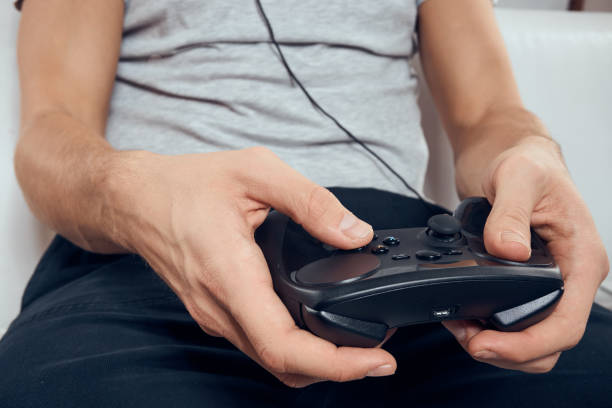 istock Gamepad male hands close-up video game addiction office technology 2054126908