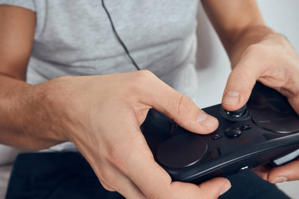 istock Gamepad male hands close-up video game addiction office technology 2054136314