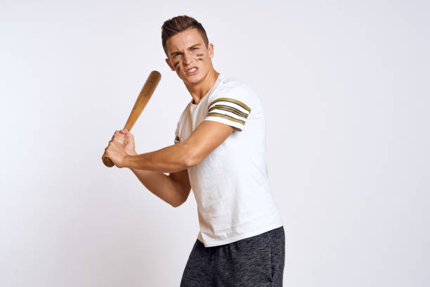 istock a man with a baseball bat on a light background exercises kicks sport ball model 2054151937