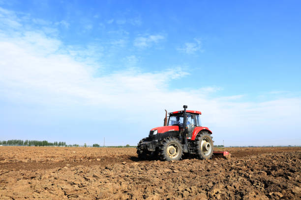 In the spring,The tractor in farmland farming