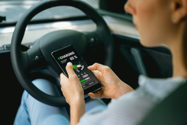 istock Young woman inside the vehicle, checking EV vehicle's application. Exalt 2054165563
