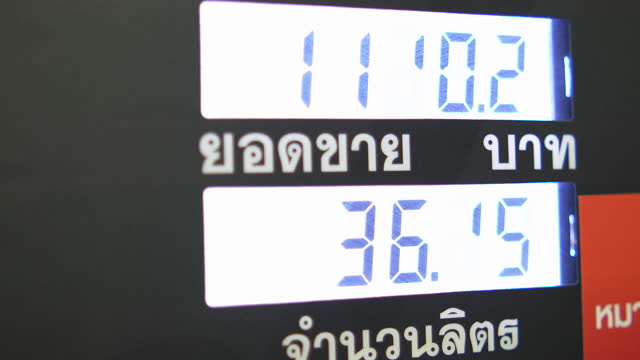 Numbers on the digital screen of the fuel dispenser while refueling at the pump.