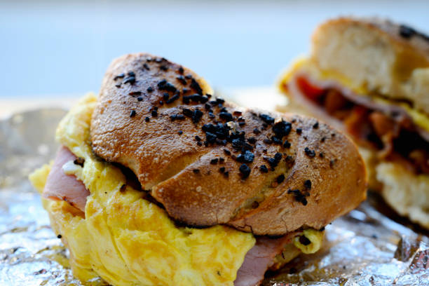 Garlic bagel with egg and bacon, unwrapped from foil package