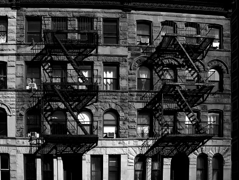 Abstract architectural geometry of old buildings with fire escape ladders