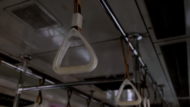 Hanging strap handrails in metro car
