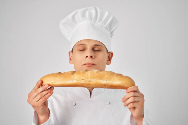 istock male chef with a baguette in his hands fresh product professional work 2054220540