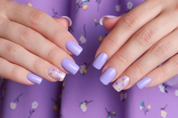 istock Female hands with purple manicure nails 2054222638