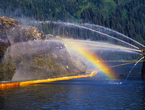 Valdez oiled spill, rainbow, fire hose, water, oil boom