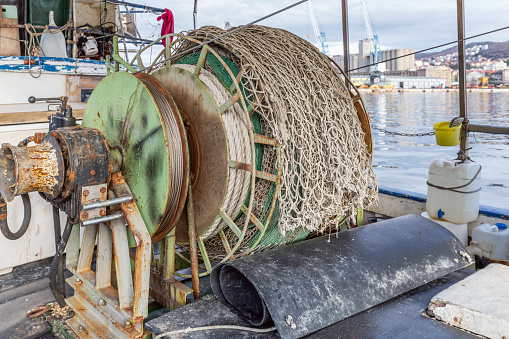 Coiled fishing net on a fishing boat in the port of Rijeka