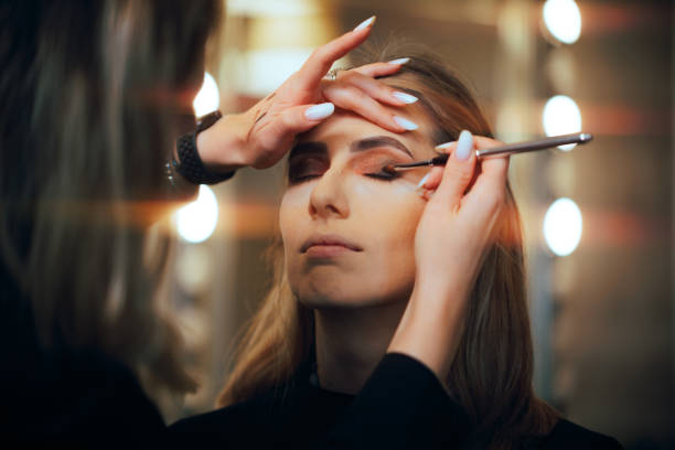 istock Professional Makeup Artist Applying Eyeshadow on a Model 2054301905