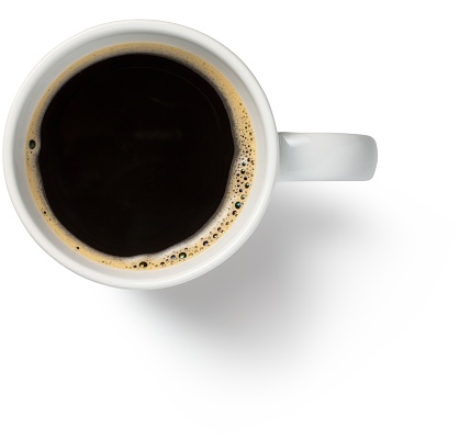 Top view of white cup with black coffee.  Close-up